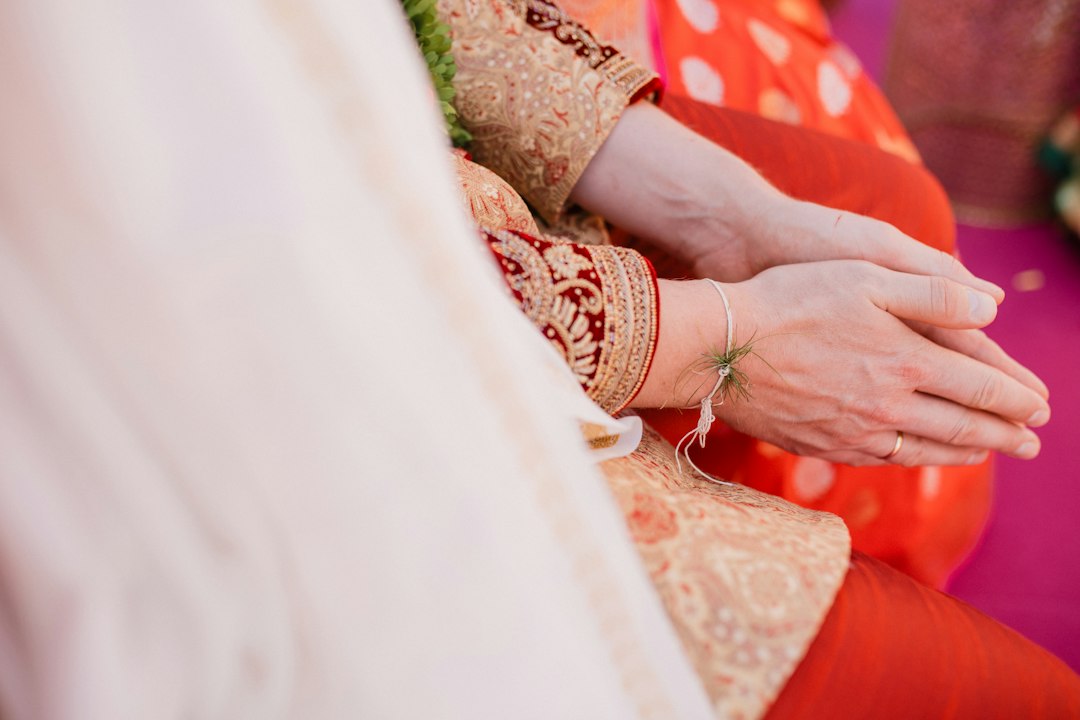 Hands in red bridal silk